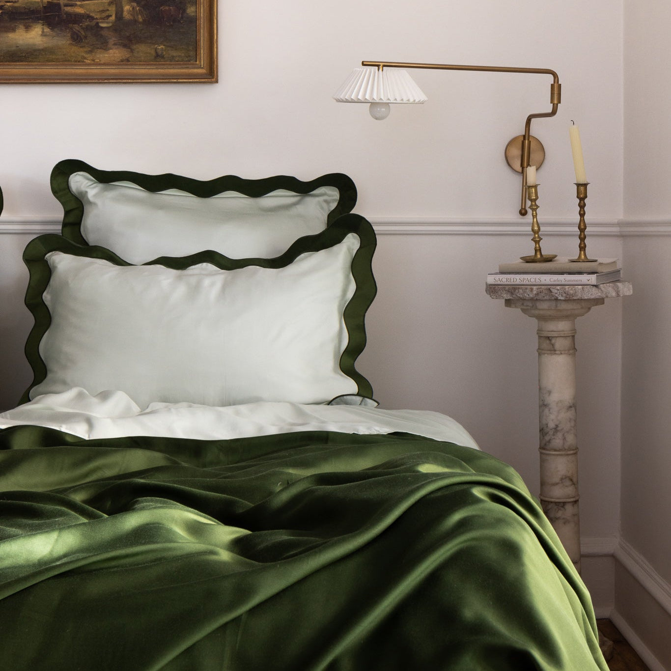 Luxury eucalyptus TENCEL™ lyocell sheets by Eucalypso with green scalloped pillowcases and cooling duvet on a styled bed