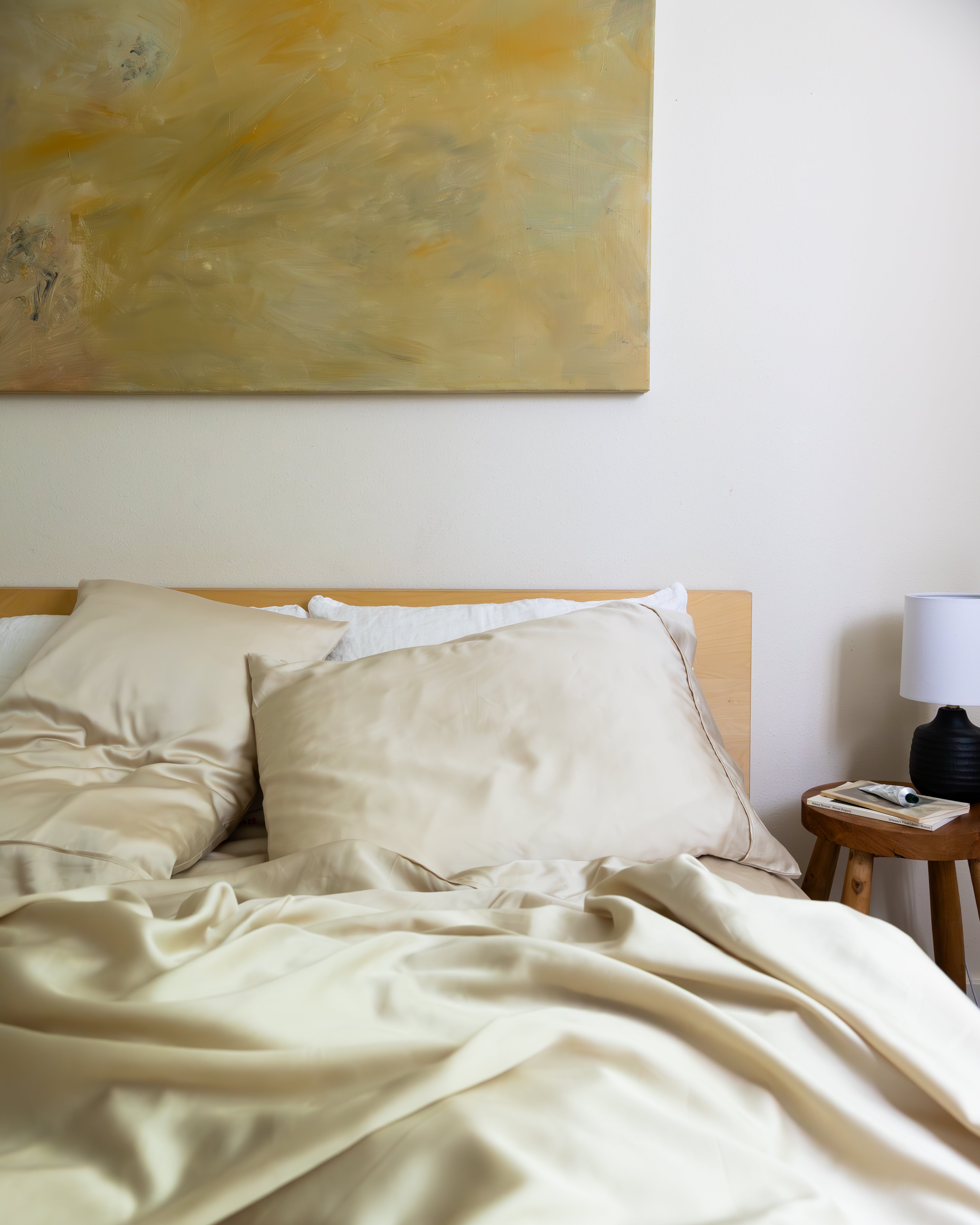 Incredibly soft and comfortable eucalyptus sheets in beige styled in bed with soft lighting